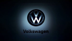 Volkswagen Emblem Illuminated Against a Dark Gradient Background HD wallpaper