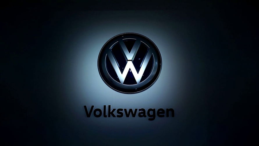 Volkswagen Emblem Illuminated Against a Dark Gradient Background HD wallpaper