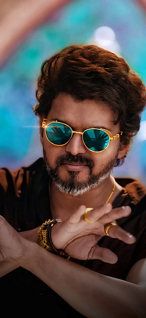 Thalapathy Vijay in BEAST with gold sunglasses and jewelry against a vibrant blue background HD phone wallpaper