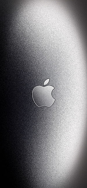 Apple Logo on Brushed Aluminum Surface with Dramatic Spotlight HD phone wallpaper