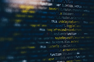 Blurred JavaScript Source Code on a Dark Screen with Syntax Highlighting HD wallpaper