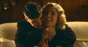 Tommy Shelby and Grace sharing an intimate moment in a dimly lit room from Peaky Blinders HD wallpaper