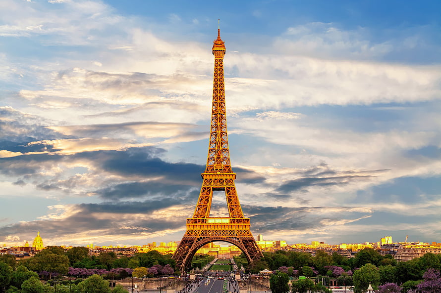 Eiffel Tower in Paris France at Golden Hour with Dramatic Clouds and City Skyline HD wallpaper