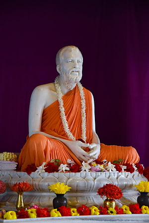 Sri Ramakrishna Statue in Orange Robes with Floral Garlands at Belur Math HD phone wallpaper