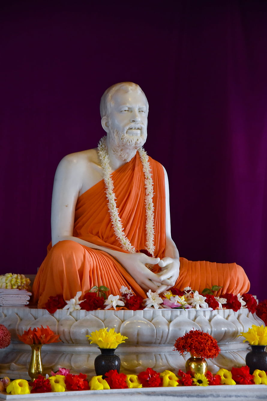 Sri Ramakrishna Statue in Orange Robes with Floral Garlands at Belur Math HD phone wallpaper