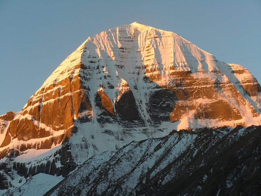 Mount Kailash Peak Bathed in Golden Sunrise Light with Snow-Capped Sides HD wallpaper