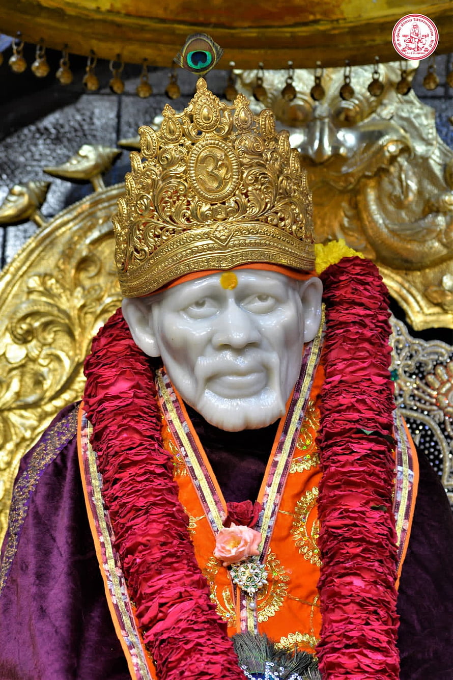 Sai Baba of Shirdi ornate golden crown and red floral garland temple statue HD phone wallpaper