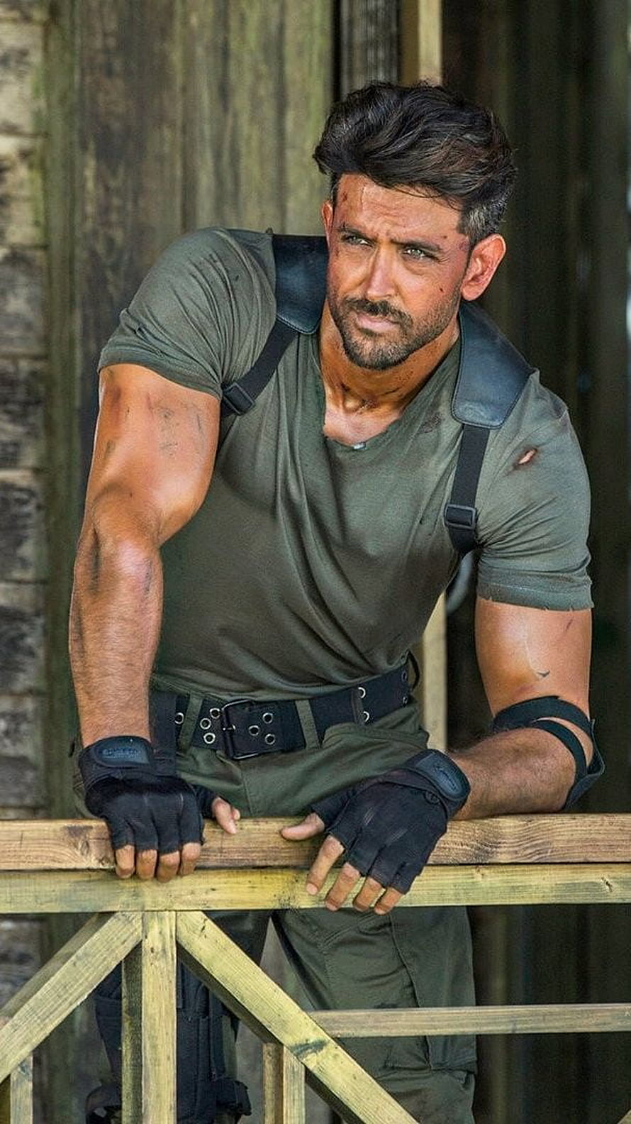 Hrithik Roshan in military tactical gear leaning on wooden railing HD phone wallpaper