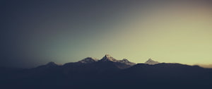 Minimalist Mountain Range Silhouette at Golden Hour with Snow-Capped Peaks HD wallpaper