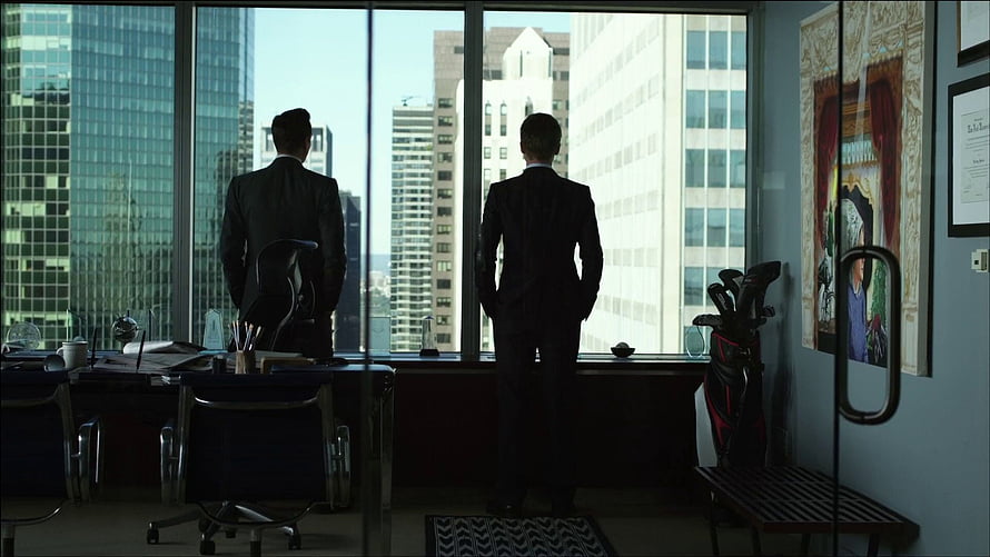 Two Men in Suits Standing in a High-Rise Office with City View HD wallpaper