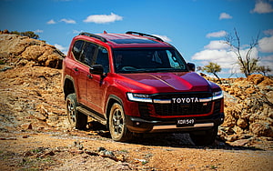 Red Toyota Land Cruiser GR Sport SUV Navigating Rocky Desert Terrain HD wallpaper