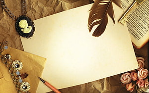 Vintage Writing Desk Scene With Cameo Brooch, Feather Quill, and Antique Book HD wallpaper
