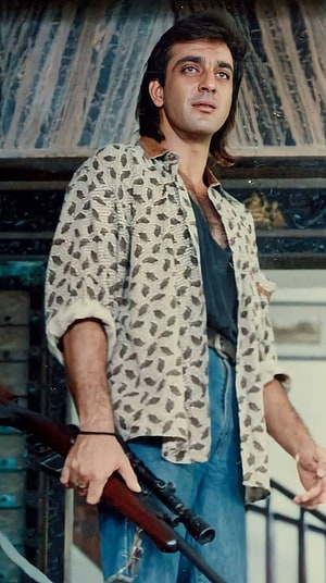 Sanjay Dutt in a vintage Bollywood action scene holding a rifle HD phone wallpaper