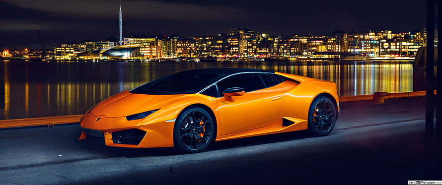 Orange Lamborghini Huracan Parked on Waterfront at Night with City Lights HD wallpaper