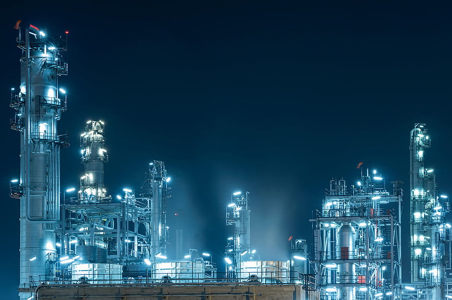 Illuminated Oil Refinery and Petrochemical Plant at Night with Glowing Industrial Towers HD wallpaper