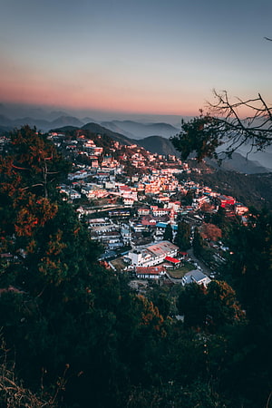 Mussoorie Hill Station at Dusk with Layered Mountain Ranges and Misty Valleys HD phone wallpaper