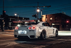 White Nissan GT-R with Liberty Walk Widebody Kit Parked on Urban Street at Night HD wallpaper