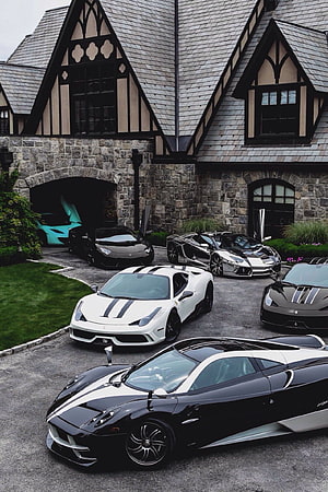 Exotic Supercar Collection Parked in Front of a Tudor-Style Stone Manor HD phone wallpaper
