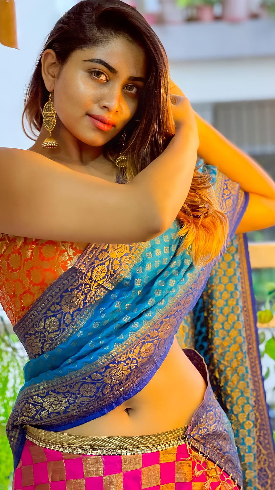 Shivani Narayanan in a vibrant blue and gold silk saree with traditional jhumka earrings HD phone wallpaper