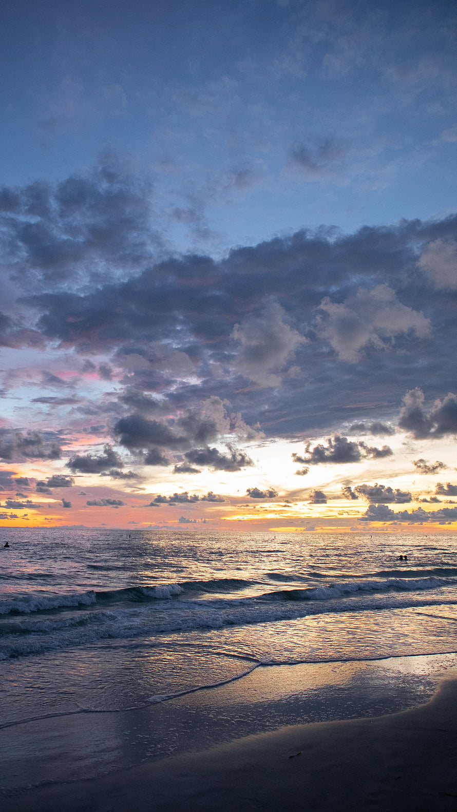 Serene Ocean Sunset with Dramatic Clouds and Gentle Waves on a Sandy Shore HD phone wallpaper