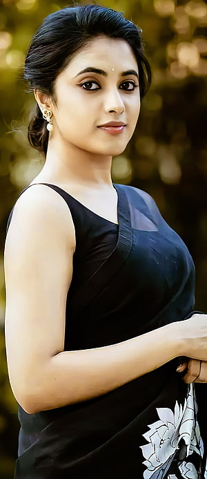 Priyanka Arul Mohan in Black Floral Saree with Gold Earrings and Soft Outdoor Portrait HD phone wallpaper