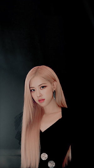 Rose from Blackpink with long pastel pink hair in a black outfit against a dark background HD phone wallpaper