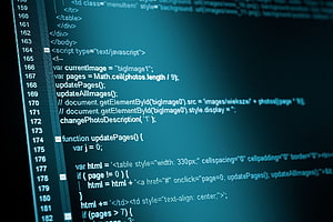 Close-up of HTML and JavaScript source code on a dark teal screen HD wallpaper