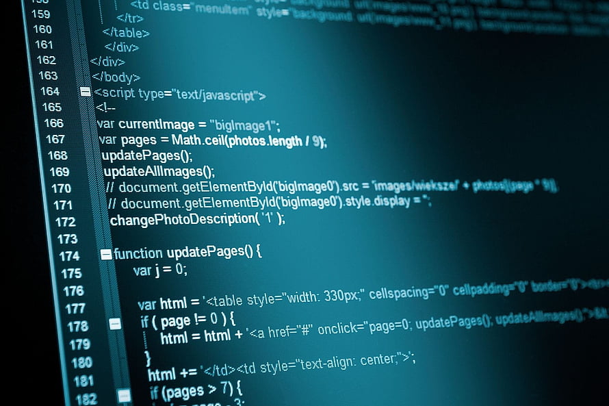 Close-up of HTML and JavaScript source code on a dark teal screen HD wallpaper