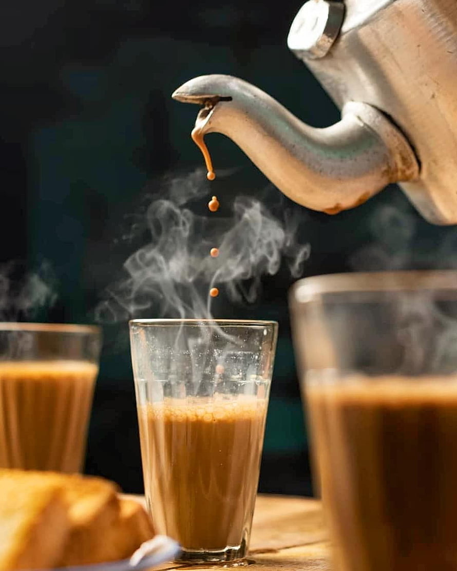 Steaming Chai Poured from a Traditional Indian Kettle into a Glass Cup HD phone wallpaper