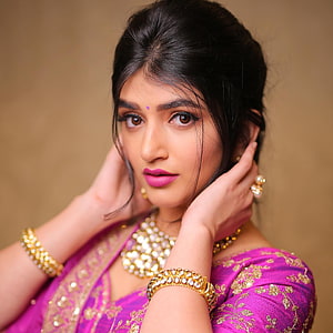 Sreeleela in a vibrant magenta sari with gold jewelry and pearl necklace HD phone wallpaper