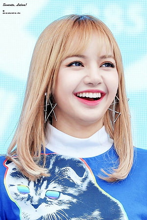 Lisa from BLACKPINK smiling in a blue cat-print top with geometric earrings HD phone wallpaper