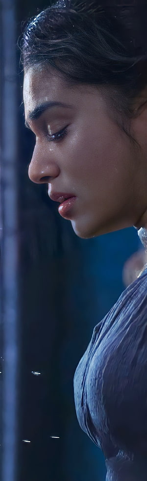 Kriti Shetty in a moody cinematic profile shot with wet hair and dramatic blue lighting HD phone wallpaper