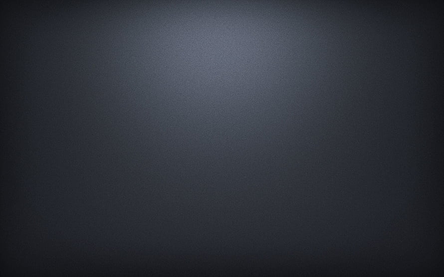 Dark Grey Textured Surface with Soft Central Light Gradient and Vignette HD wallpaper