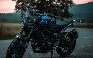 Yamaha MT-09 SP motorcycle parked on a scenic road at dusk with mountain backdrop HD wallpaper