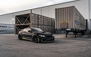 Matte Black BMW M4 F82 Coupe With Neon Accents Parked Near Shipping Containers HD wallpaper