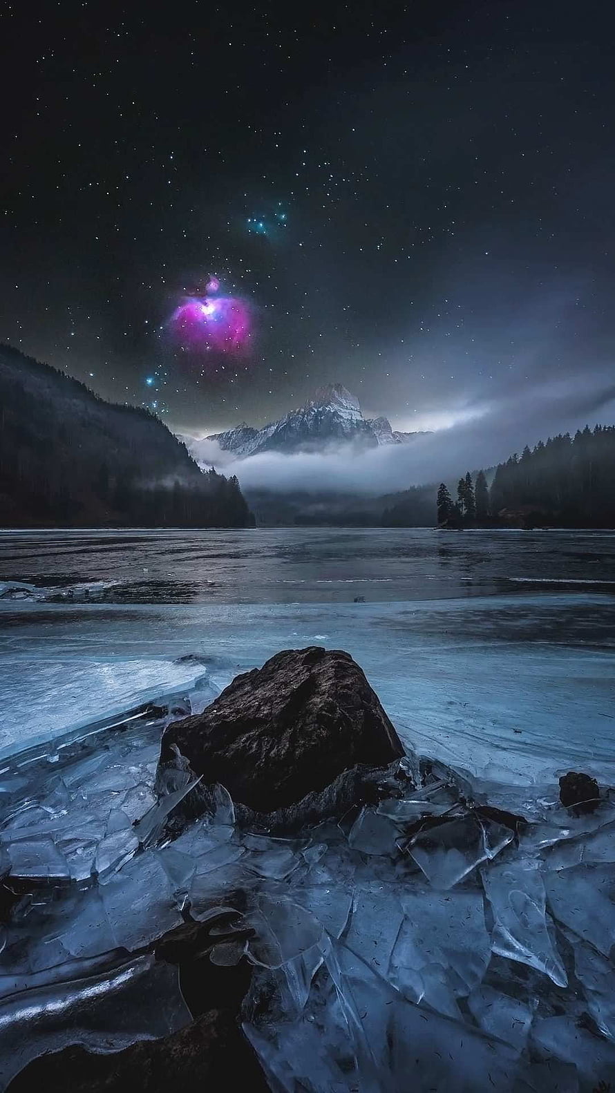 Frozen Lake at Night with Starry Sky and Distant Snow-Capped Mountain HD phone wallpaper