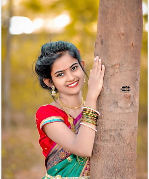 Young Indian Woman in Traditional Saree Leaning Against Tree Trunk HD phone wallpaper