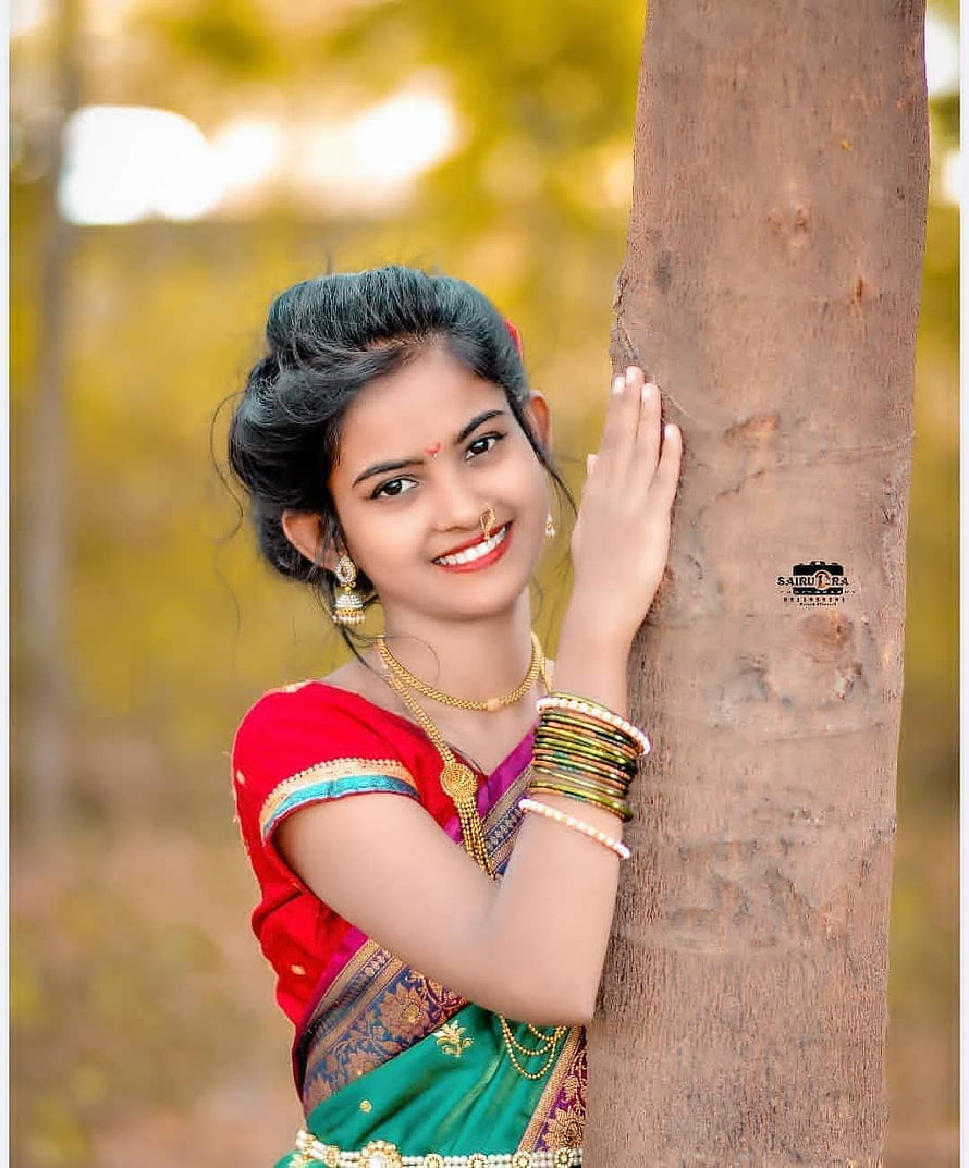 Young Indian Woman in Traditional Saree Leaning Against Tree Trunk HD phone wallpaper