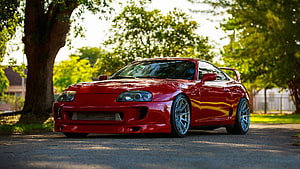 Red Toyota Supra MK4 Coupe Parked on a Tree-Lined Street HD wallpaper