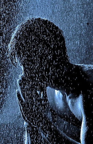 Silhouette of a man with hands clasped in face during heavy rainstorm HD phone wallpaper