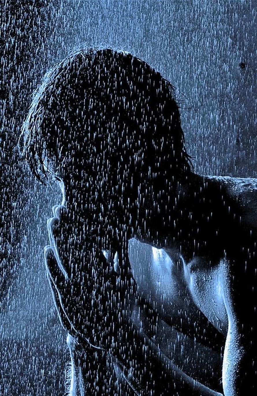 Silhouette of a man with hands clasped in face during heavy rainstorm HD phone wallpaper