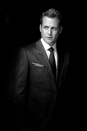 Gabriel Macht as Harvey Specter in a formal pinstripe suit against a dark background HD phone wallpaper