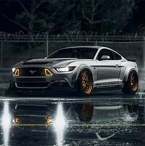 Silver Ford Mustang GT RTR with orange wheels parked on wet asphalt at night HD phone wallpaper