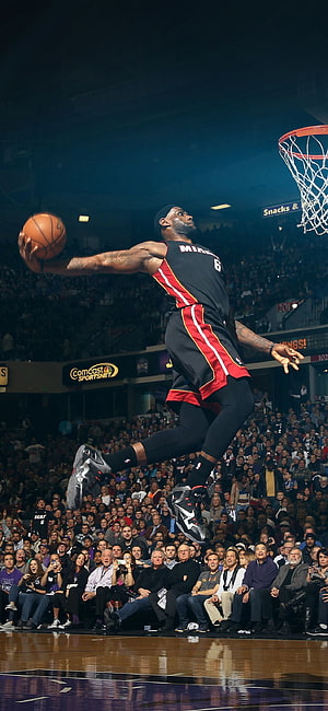 LeBron James in Miami Heat jersey executing a powerful dunk during an NBA game HD phone wallpaper