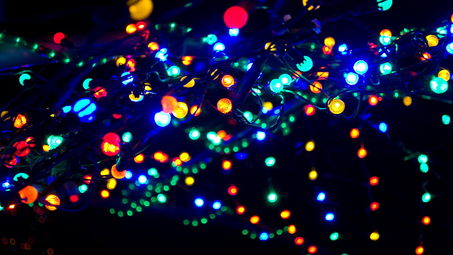 Vibrant Multicolored Christmas Lights Bokeh Against a Dark Night Sky HD wallpaper