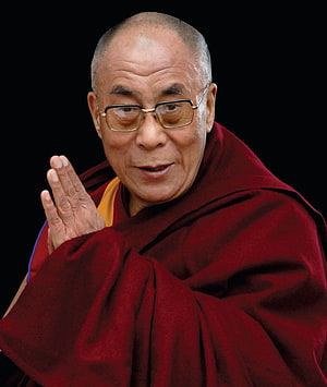 Dalai Lama in Maroon Robes with Hands in Prayer Gesture Against Black Background HD phone wallpaper