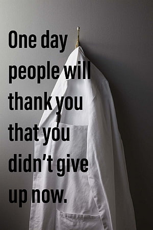 White Doctor Coat Hanging on Wall with Motivational Quote About Perseverance HD phone wallpaper
