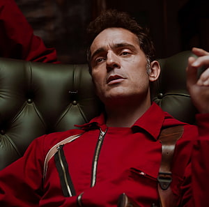 Money Heist Character in Red Jumpsuit Reclining on Tufted Leather Chair HD wallpaper