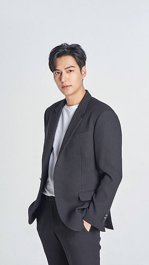 Lee Min Ho in a dark tailored blazer and white t-shirt against a clean studio backdrop HD phone wallpaper