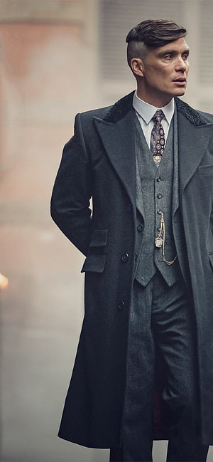 Tommy Shelby in a dark overcoat and waistcoat from Peaky Blinders HD phone wallpaper